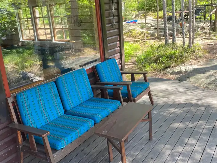 The covered porch with blue sofas