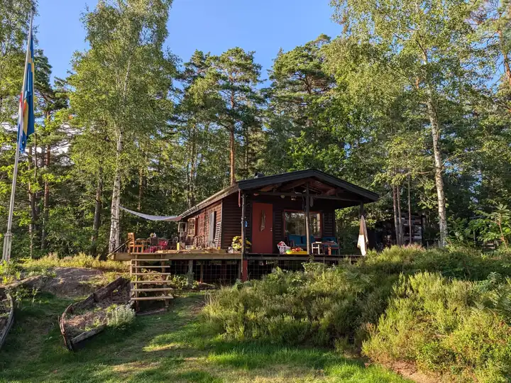 The main cabin and its deck, seen from the meadow