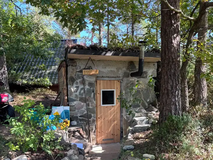 The stone sauna with its wooden door